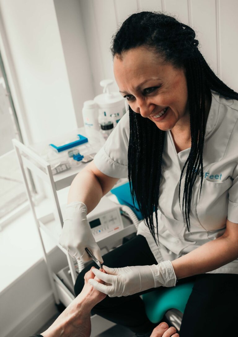 Angela Churchill podiatrist and chiropodist working on a patient